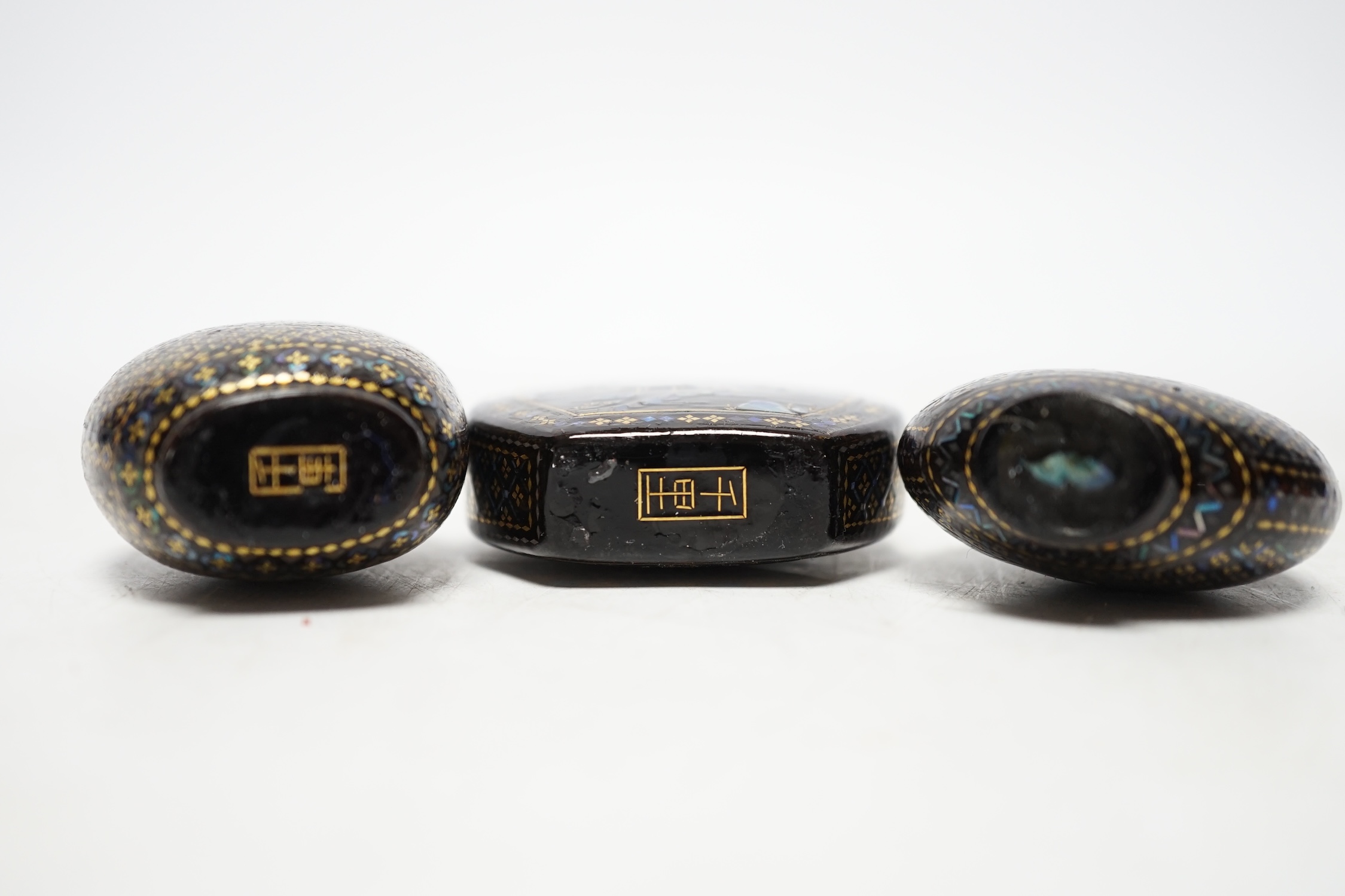 Three Chinese lac burgaute snuff bottles, 19th/20th century, largest 6cm high